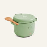The Rice Cooker features fuzzy logic, a green finish, a digital display, a closed lid, and comes with a wooden spatula—expertly engineered for perfect rice every time.
