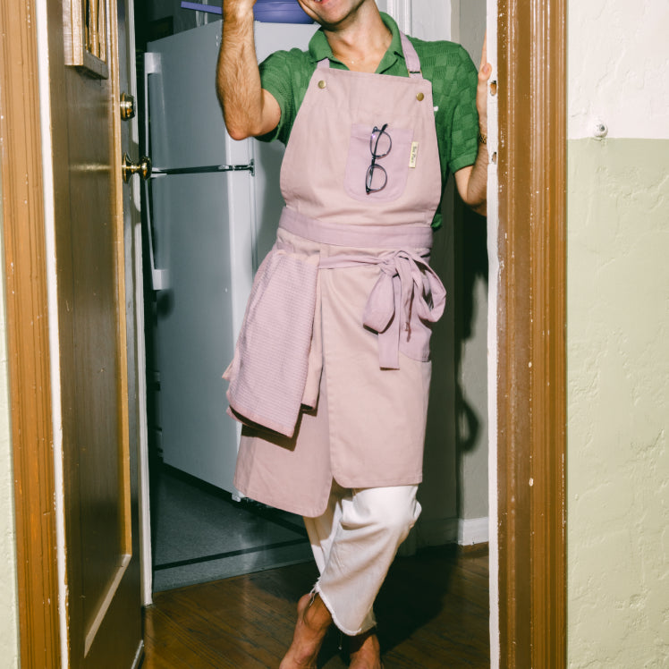 A chef wears a purple Home Cook Apron