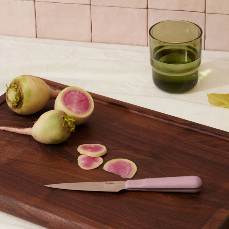 purple precise paring knife on walnut cutting board with raddishs