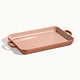 Copper-colored rectangular tray with handles on a white background