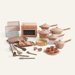 Collection of toy kitchen appliances and utensils on a white background