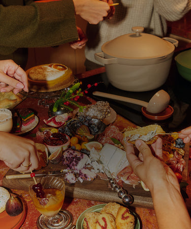 Diverse food items on a table with a pot in the center.