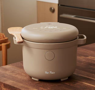 Beige rice cooker on a wooden countertop