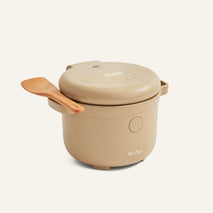 Beige Rice Cooker with fuzzy logic, digital display, closed lid, and wooden spatula on the handle; 
