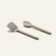 Titanium Pro Utensil Set including a metal spatula with a light-colored handle and a matching light-colored solid spoon.